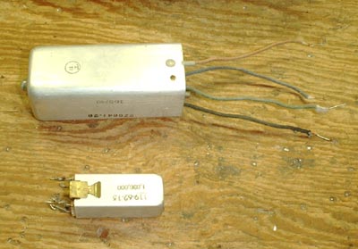  Photo, two I F transformers.  Large has wire leads and mounting studs.  Small has solder lugs and sprint clip mounting.